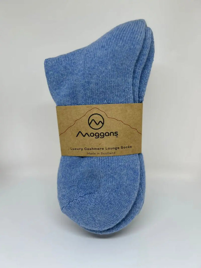 A pair of blue Moggans Cashmere Bed Socks - Made in Scotland, with a brown label, is shown against a plain white background.