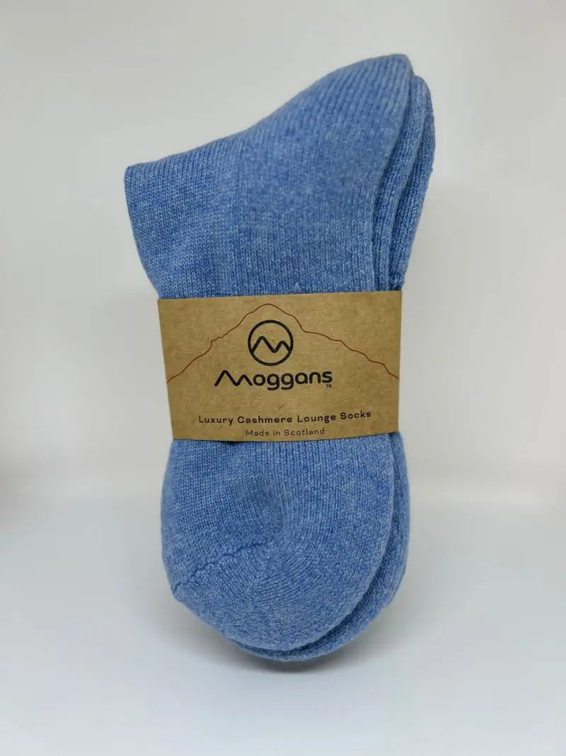 A pair of blue Moggans Cashmere Bed Socks - Made in Scotland, with a brown label, is shown against a plain white background.