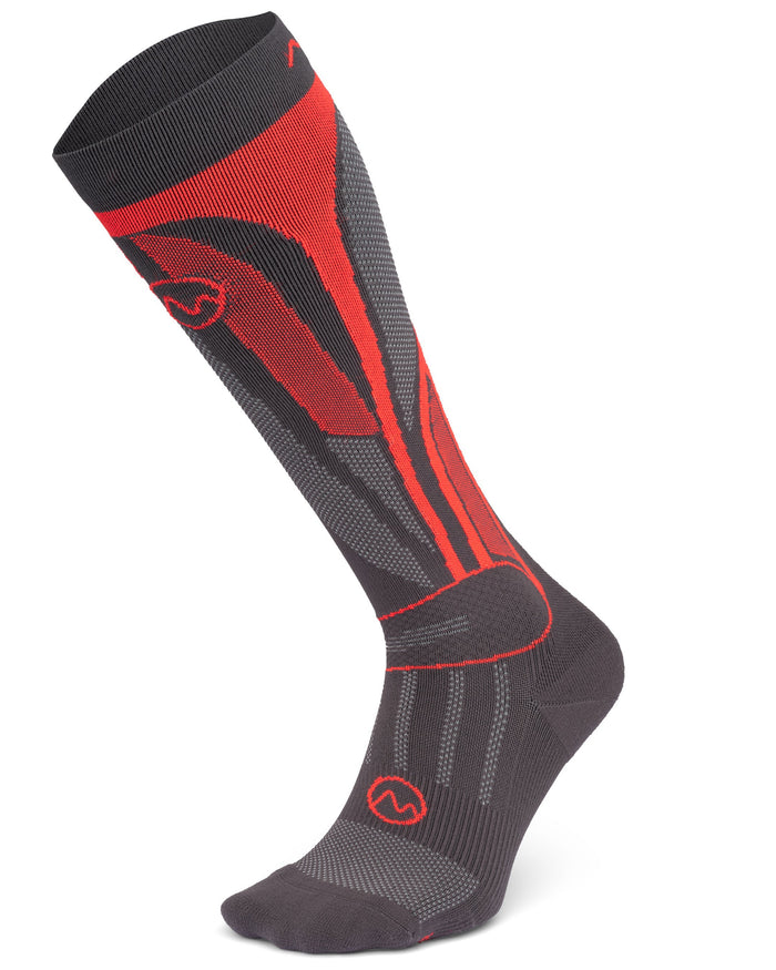 The Moggans High Performance Ski Racing Sock is a single black and red knee-high sock with geometric patterns and circular logos, designed for targeted compression and optimal temperature control, shown upright on a white background.