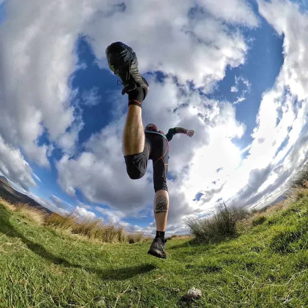 Trail runner wearing Moggans merino socks on a mountain path