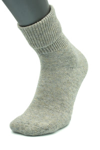 The Moggans NEW for 2025 Cashmere Luxury Bed Socks, made in Scotland, are shown in gray on a mannequin foot with a ribbed cuff and textured fabric, set against a white background.