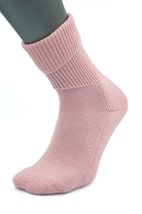 A mannequin leg models a single pink, ribbed, crew-length Moggans Cashmere Luxury Bed Sock—made in Scotland—set against a white background.
