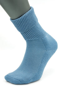 A mannequin foot wears a light blue, ribbed crew sock—Moggans Cashmere Luxury Bed Socks, made in Scotland—displayed on a plain white background.