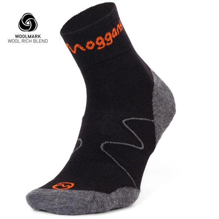 A black and grey Moggans Lightweight Merino Ankle Sock with orange accents stands upright to show the heel, toe, and side. The Woolmark logo and “WOOL RICH BLEND” text are displayed in the top left corner.