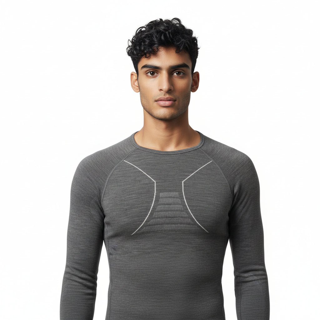 Men's Moggans Schiehallion Merino Wool Base Layer in charcoal grey, chest detail view. 220gsm seamless construction with crew neck for alpine skiing and cold-weather activities.
