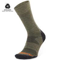 The Moggans Hiking Midweight Merino Crew Sock in olive green and dark gray features reinforced heel and toe, orange toe lettering, and a Woolmark logo—ideal for outdoor adventures and those seeking reliable merino hiking socks.