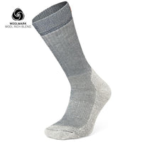 The Moggans Merino Hiking Socks - Stravaiger, made in Scotland, are single gray wool-blend socks with darker gray at the top and lighter gray on heel and toe. The Woolmark Wool Rich Blend logo appears in the top left corner.