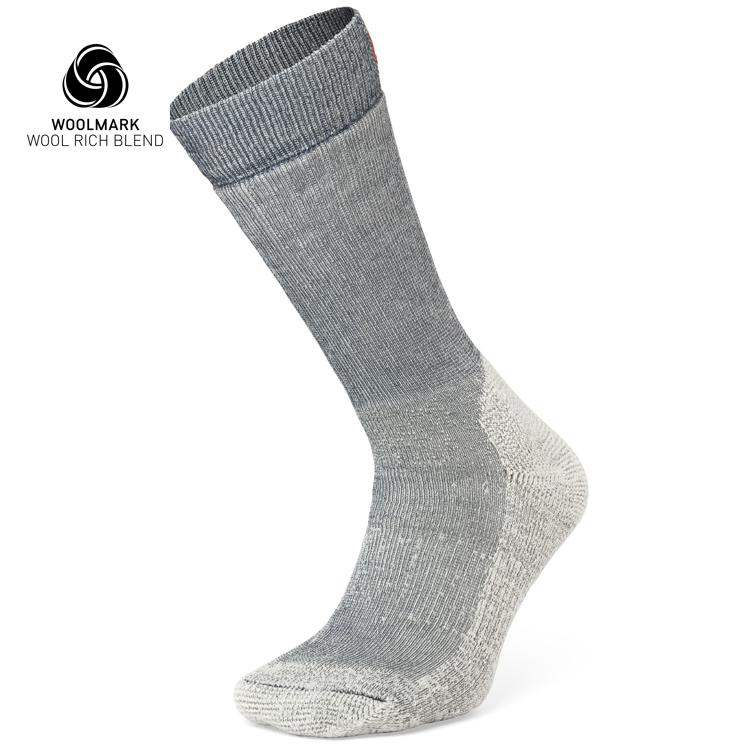 The Moggans Merino Hiking Socks - Stravaiger, made in Scotland, are single gray wool-blend socks with darker gray at the top and lighter gray on heel and toe. The Woolmark Wool Rich Blend logo appears in the top left corner.