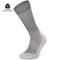 The Moggans Merino Hiking Socks - Stravaiger, made in Scotland, are gray wool-blend crew socks with lighter gray heel, toe, and sole. Displayed upright with Woolmark logo and “Wool Rich Blend” text—ideal for hiking.
