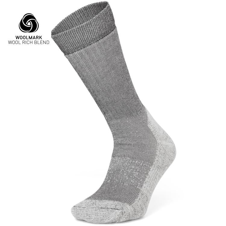 The Moggans Merino Hiking Socks - Stravaiger, made in Scotland, are gray wool-blend crew socks with lighter gray heel, toe, and sole. Displayed upright with Woolmark logo and “Wool Rich Blend” text—ideal for hiking.
